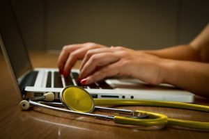 A healthcare professional using identity management systems to secure sensitive patient data, ensuring privacy and compliance within the healthcare industry.
