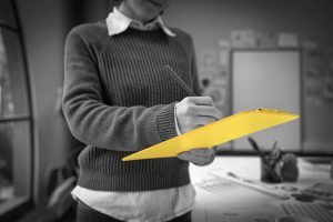 A person crafting a detailed job description, highlighting key responsibilities, required skills, and qualifications to attract top talent and ensure role clarity.